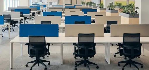 Modern open-plan office space featuring clean workstations, ergonomic chairs, and sanitized carpets provided by professional office cleaning services in Duluth, MN.
