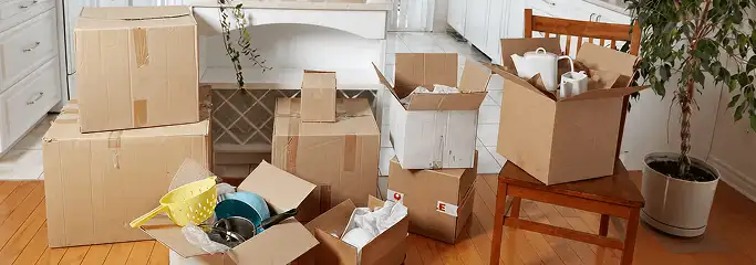 Packed moving boxes and household items in a kitchen before move-out or move-in cleaning, Duluth, MN.